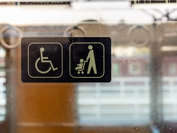 disabled passenger and parent child priority sticker on window of public transport 
